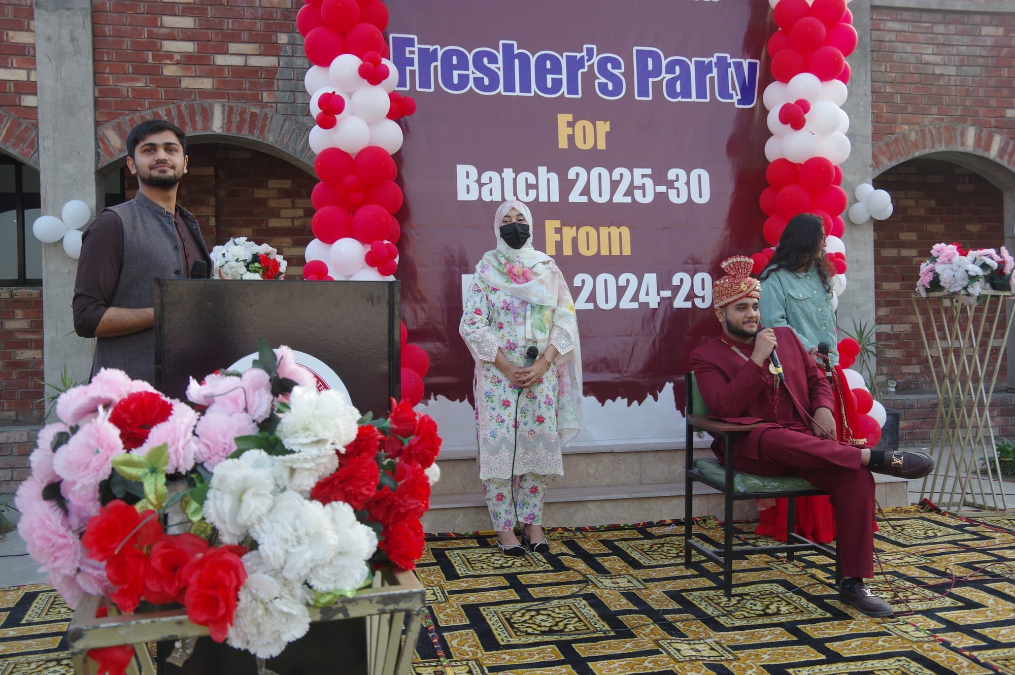 Students speaking on stage at the Freshers' Party