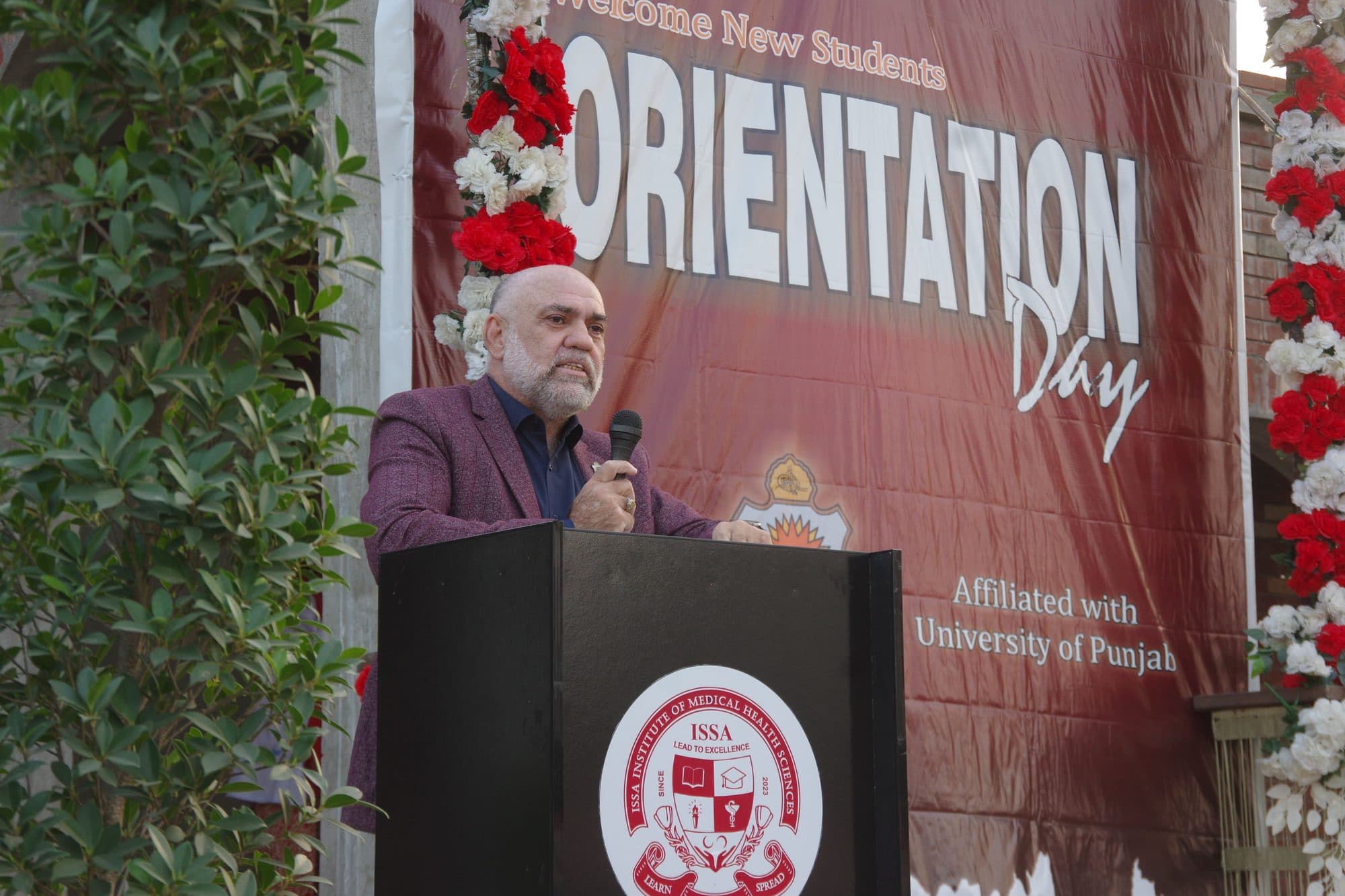 A speaker addressing new students from the Orientation Day lectern