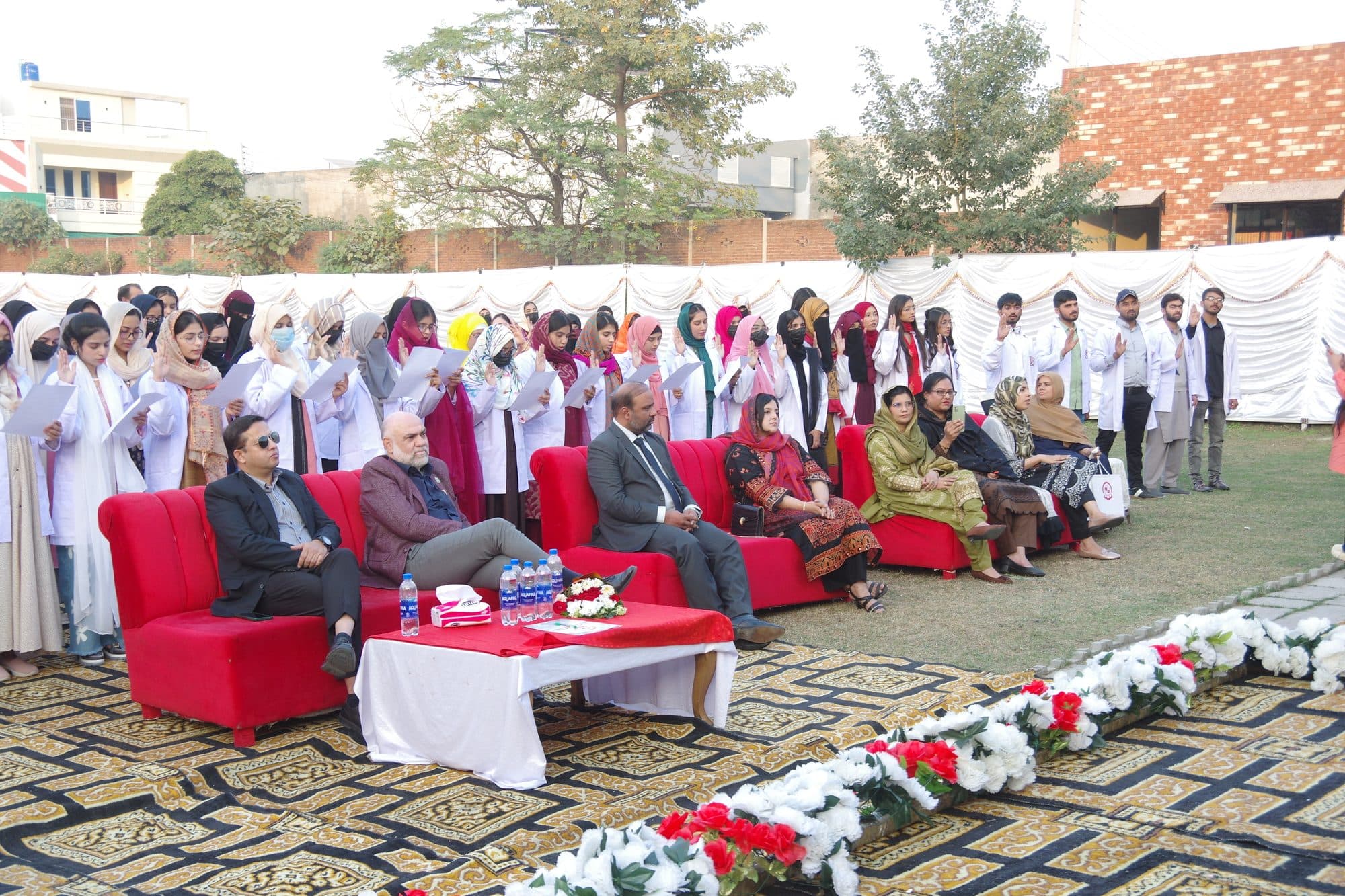 Guests and faculty seated in front of students taking the oath at Orientation Day