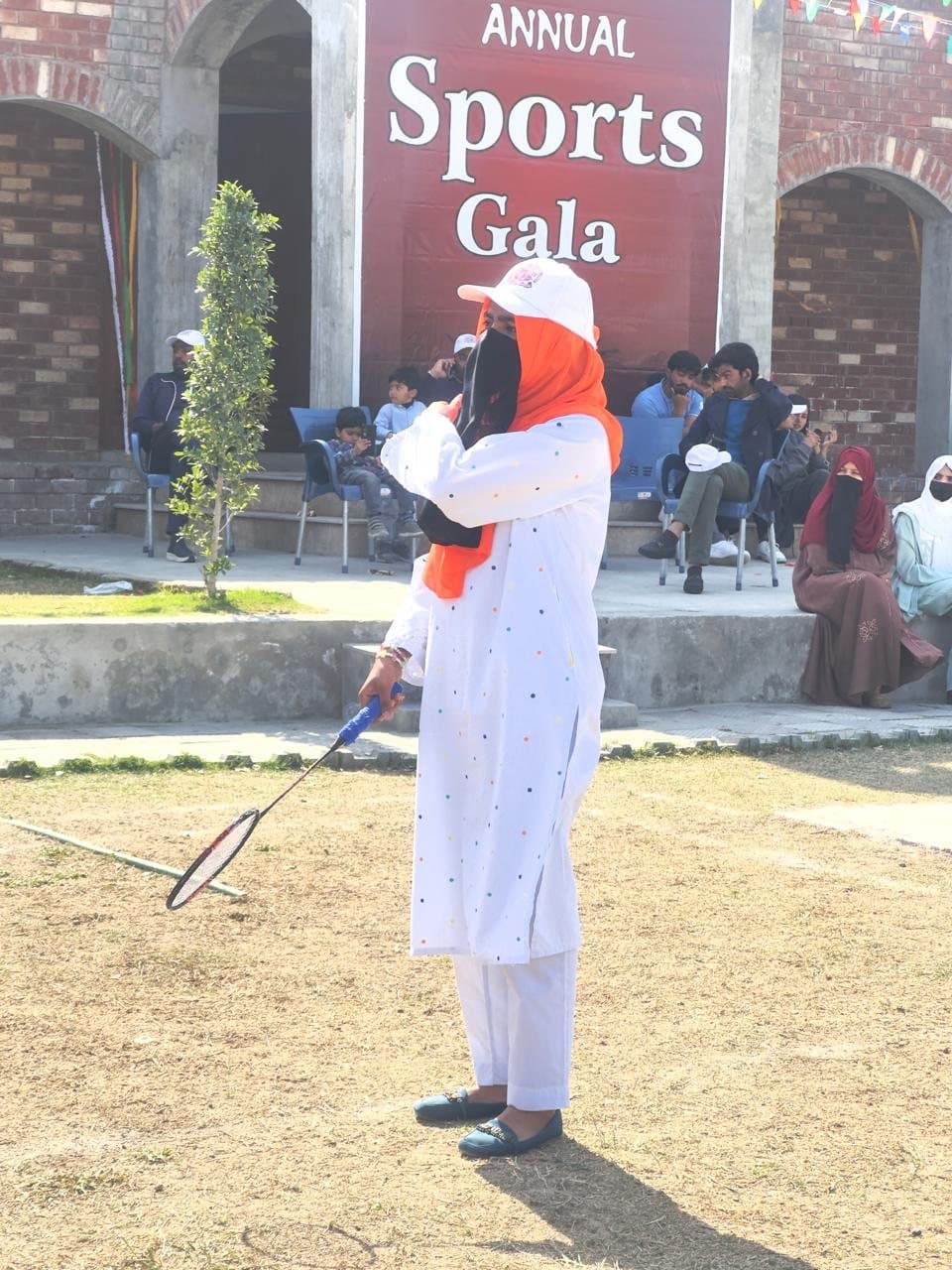A student playing badminton on the ISSA ground during the Sports Gala