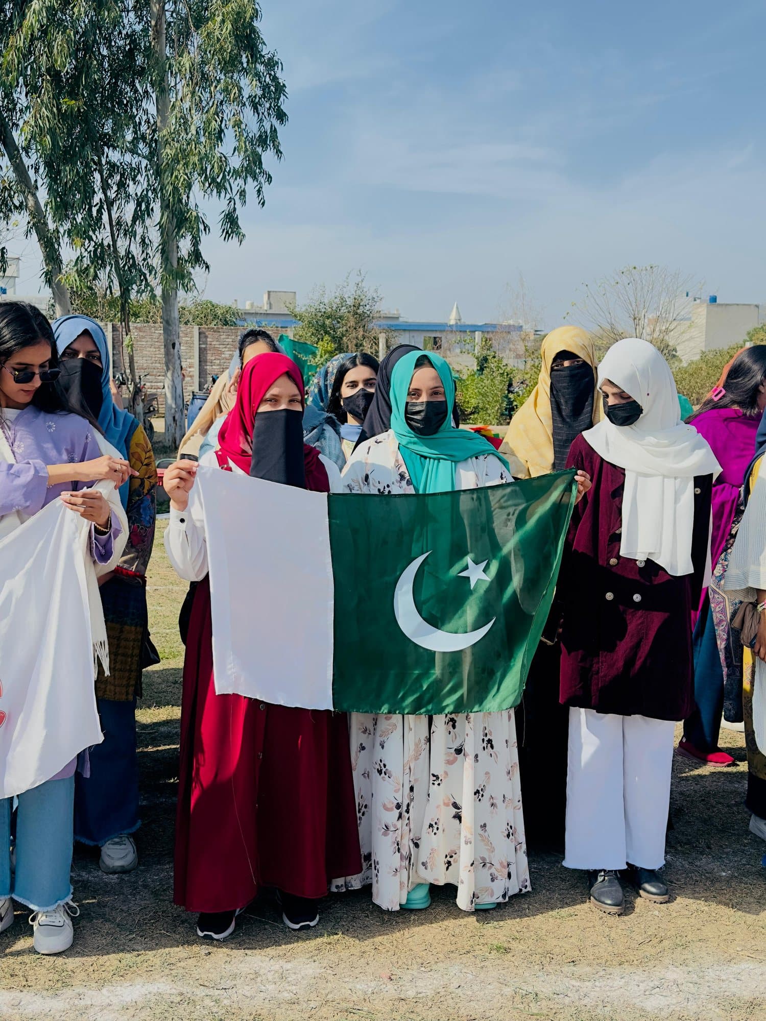 Students holding the Pakistan flag at the Sports Gala
