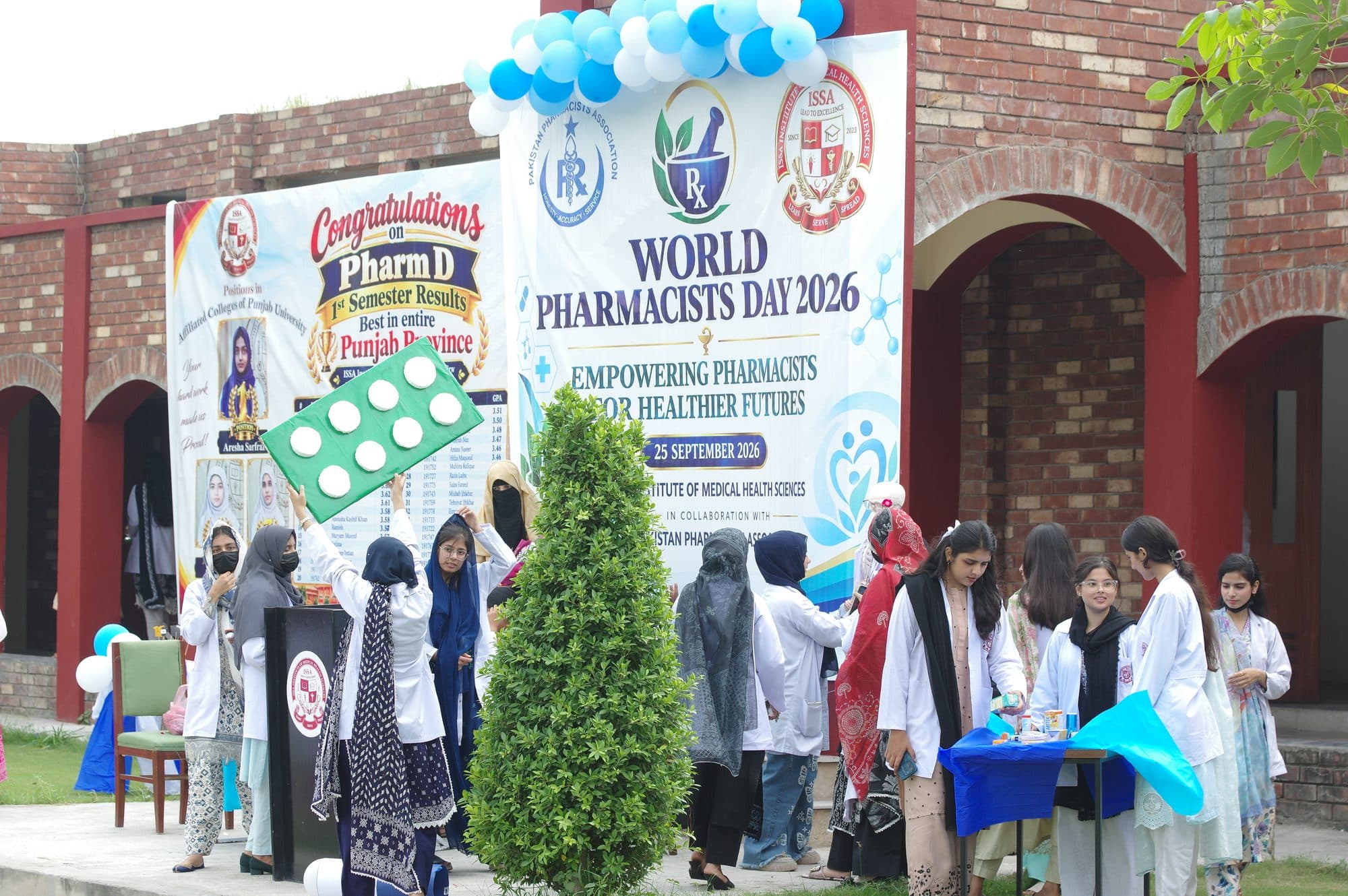 Students at a pharmacy display set up for World Pharmacists Day
