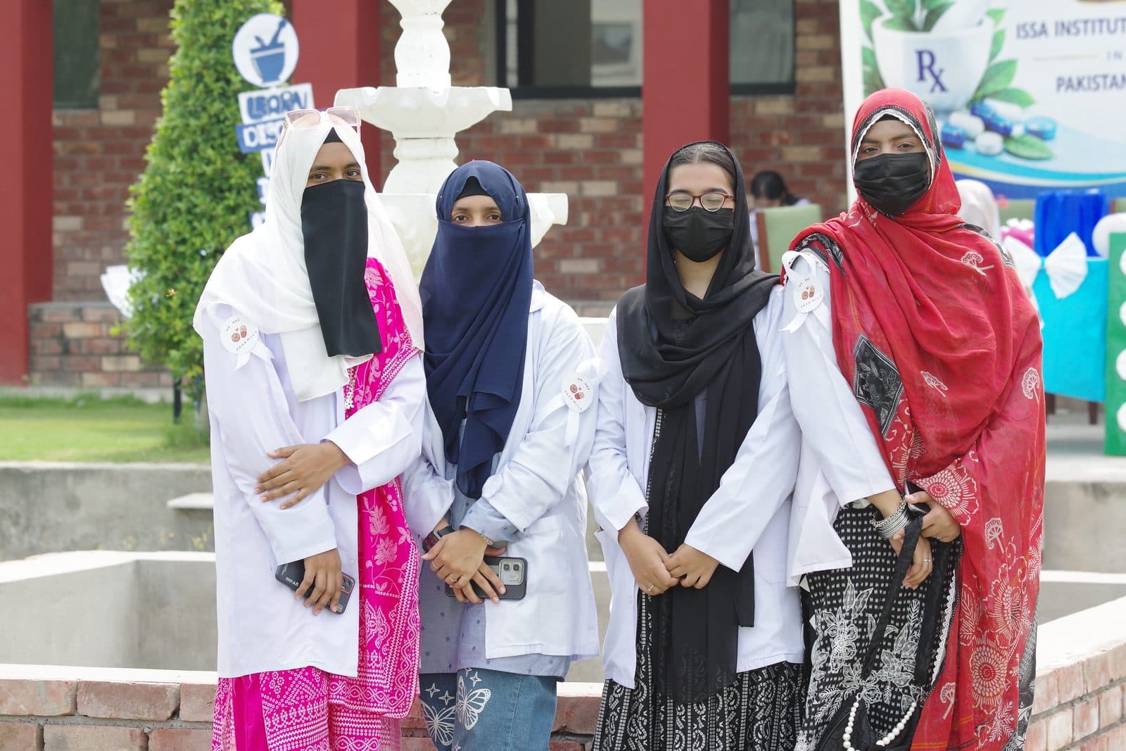 ISSA pharmacy students in white coats on World Pharmacists Day 2026